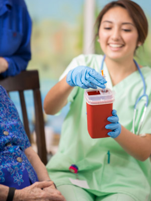 Nurse demonstrating disposal of medications and syringes