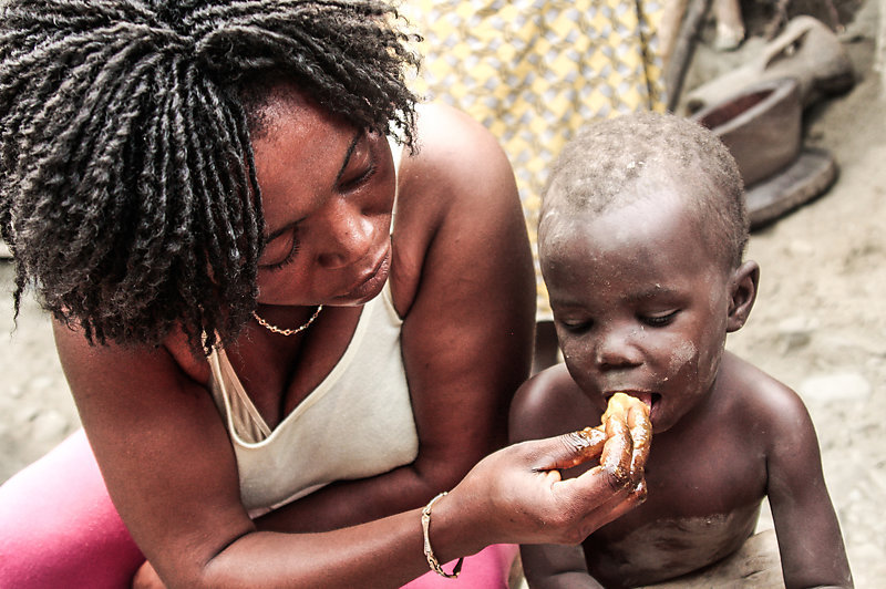 Ghanaian mother feeding her child.