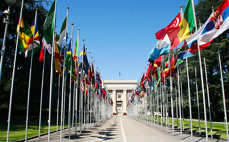 Row of flags at the entrance of the United Nations building in Geneva, Switzerland.