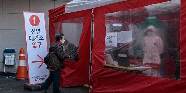 TOPSHOT - An elderly woman enters a COVID-19 novel coronavirus testing booth outside the Yangji hospital in Seoul on March 17, 2020. - A South Korean hospital has introduced "phone booth"-style coronavirus testing facilities that avoid medical staff having to touch patients directly and cut down disinfection times. (Photo by Ed JONES / AFP) (Photo by ED JONES/AFP via Getty Images)
