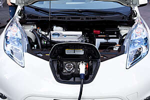 The electrical charging point and engine of a Nissan Leaf zero emission car.